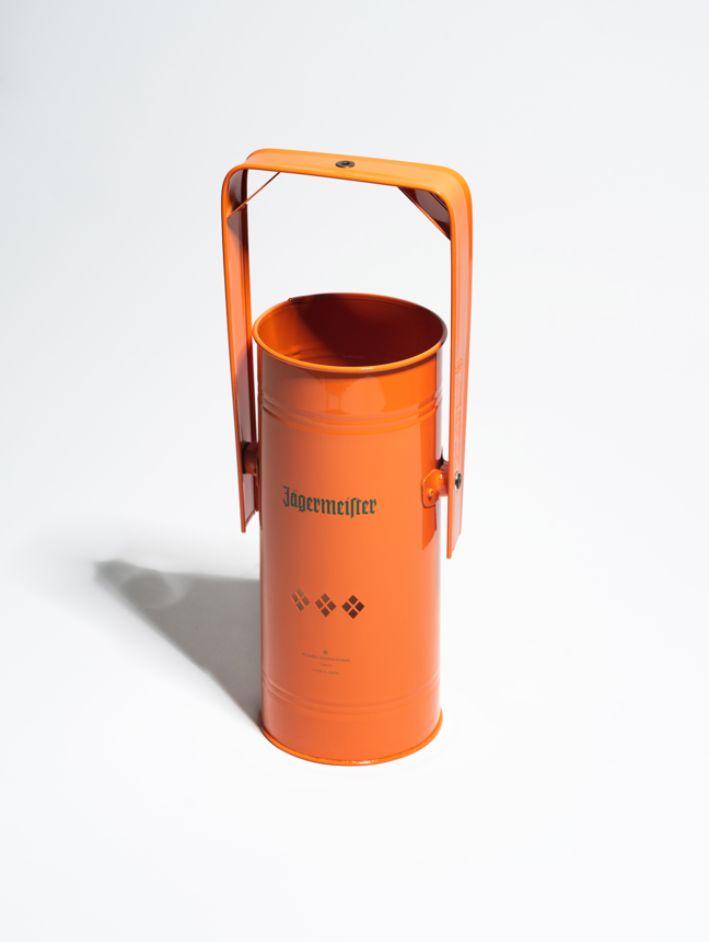 Orange metal incense burner with handle and green Jägermeister logo on a white background