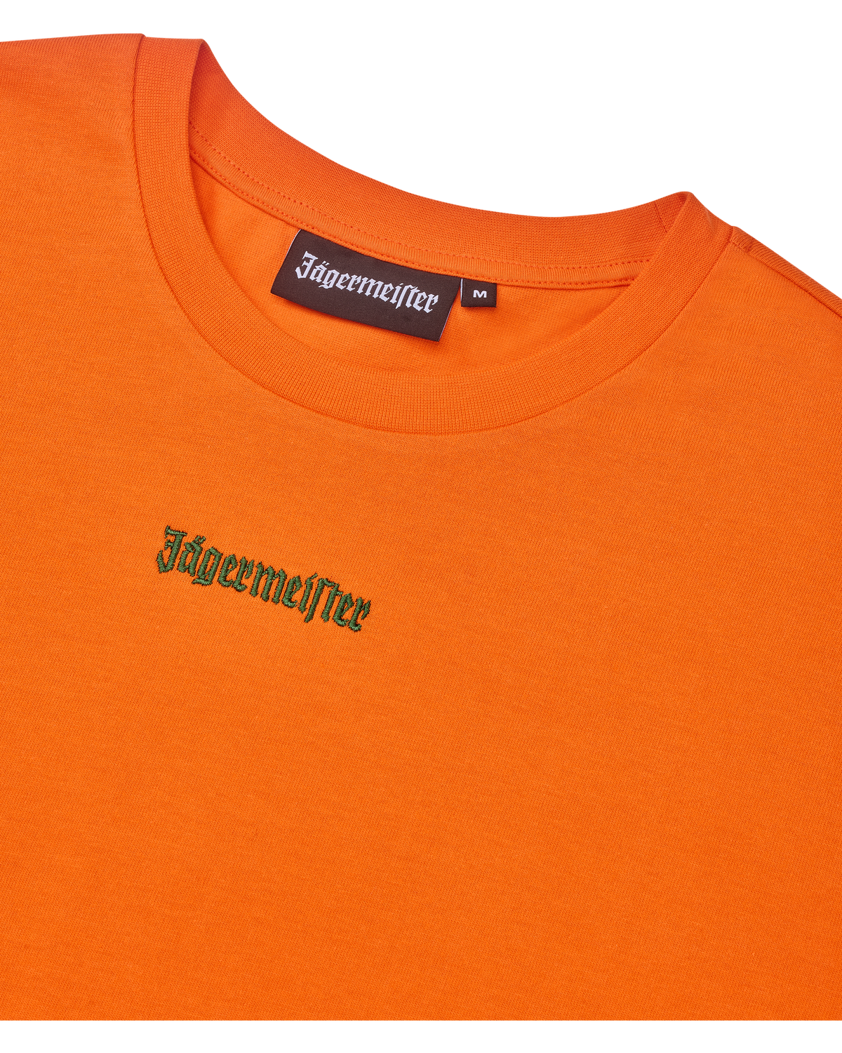 Cropped tee arancione con logo verde Jägermeister.