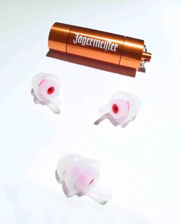 Three earplugs and an orange metal case with a white Jägermeister wordmork on it 