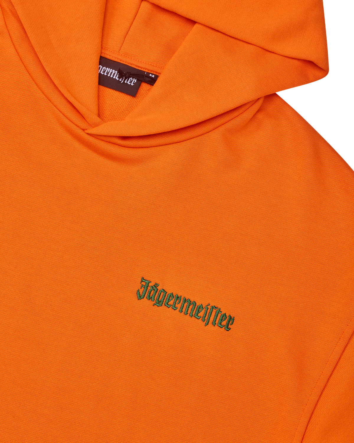 Felpa con cappuccio arancione con wordmark Jägermeister verde sul petto.
