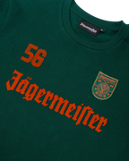 Maglia a maniche lunghe verde Jägermeister con scritta Jägermeister arancione e un '56'.