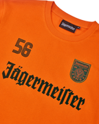 Maglia a maniche lunghe arancione Jägermeister con scritta Jägermeister nera e un '56'.