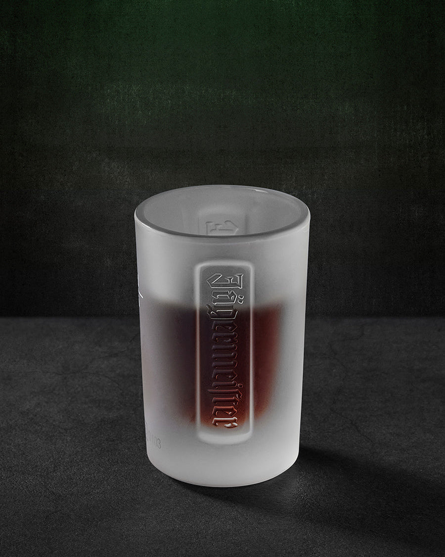 Bicchiere shot Jägermeister bianco con wordmark Jägermeister in rilievo
e liquido all’interno