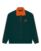 Giacca da tuta verde Jägermeister con colletto arancione e logo Jägermeister arancione sul petto.