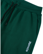 Pantaloni della tuta Jägermeister verdi con logo bianco.