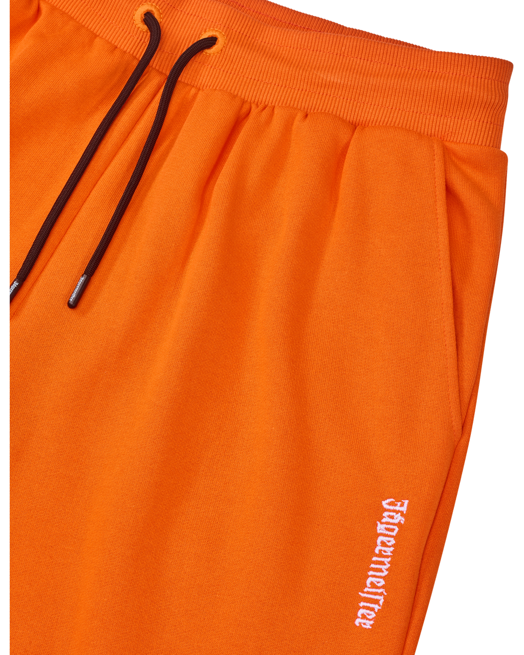 Pantaloni della tuta Jägermeister arancioni con cordino nero e logo bianco.